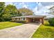 Beautiful red brick home with carport and well-maintained lawn, exudes timeless charm and comfort at 5040 Lancaster St, North Charleston, SC 29405