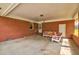 A large carport features brick walls, white trim, and a seating area for outdoor relaxation at 5040 Lancaster St, North Charleston, SC 29405