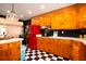 Spacious kitchen featuring knotty pine cabinets, black backsplash, and red retro-style refrigerator at 5040 Lancaster St, North Charleston, SC 29405