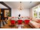 Bright dining area features hardwood floors, a unique floral couch, and modern lighting at 5040 Lancaster St, North Charleston, SC 29405