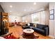 Open living room with hardwood floors, modern lighting, and a comfortable black leather sofa at 5040 Lancaster St, North Charleston, SC 29405