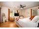 Main bedroom features a ceiling fan, hardwood floors, and two windows at 5040 Lancaster St, North Charleston, SC 29405