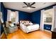 Comfortable main bedroom features hardwood floors, a large window, and stylish furnishings at 5040 Lancaster St, North Charleston, SC 29405