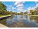 A scenic pond reflecting the sky, surrounded by trees and providing a serene natural setting at 5040 Lancaster St, North Charleston, SC 29405