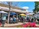 Outdoor dining at AZUL Mexican restaurant, featuring colorful umbrellas and vibrant pink flowers at 5040 Lancaster St, North Charleston, SC 29405