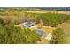 Expansive aerial view of the property, featuring a house and outbuilding, set against a backdrop of lush greenery at 508 Horse Trail Rd, Saint George, SC 29477