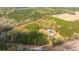 Aerial view showcasing the layout of the house and metal outbuilding on a tree-filled property at 508 Horse Trail Rd, Saint George, SC 29477