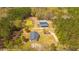 Overhead view of the house and outbuilding, nestled amidst a canopy of trees and a serene pond nearby at 508 Horse Trail Rd, Saint George, SC 29477