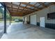 Open barn featuring a large garage area with high ceilings and a view of the surrounding property at 508 Horse Trail Rd, Saint George, SC 29477