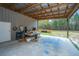 Side view of a metal barn with an attached covered area, with open space for projects and storage at 508 Horse Trail Rd, Saint George, SC 29477