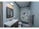 Bathroom with gray walls, a dark vanity, framed mirror, and an enclosed shower with tiled walls at 508 Horse Trail Rd, Saint George, SC 29477