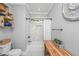 Bathroom with a tub, shower, tiled walls, and open shelving for storage with decorative elements at 508 Horse Trail Rd, Saint George, SC 29477