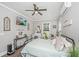 A modern bedroom setup featuring a mounted television, ceiling fan, and vanity area at 508 Horse Trail Rd, Saint George, SC 29477