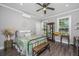 Charming bedroom with wood floors, ceiling fan, and a display cabinet with decorative items at 508 Horse Trail Rd, Saint George, SC 29477