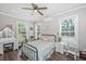 Cozy bedroom with a ceiling fan, desk, and vanity, illuminated by natural light from multiple windows at 508 Horse Trail Rd, Saint George, SC 29477