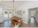 Charming dining area with a wooden table, chandelier, and white cabinets at 508 Horse Trail Rd, Saint George, SC 29477