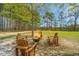 Cozy fire pit area with Adirondack chairs providing a perfect spot for gathering and enjoying the outdoors at 508 Horse Trail Rd, Saint George, SC 29477