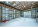 A functional garage interior with high ceilings, ample lighting, and exposed wood beams, ideal for workshop or storage at 508 Horse Trail Rd, Saint George, SC 29477
