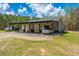 A detached garage offers multiple bays with roll-up doors, covered parking, and a workspace, set on a grassy lot at 508 Horse Trail Rd, Saint George, SC 29477