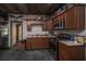 Kitchenette features a wood ceiling, stainless steel appliances, custom wood cabinets, and a dual basin sink at 508 Horse Trail Rd, Saint George, SC 29477