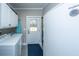 Laundry room with a washer, dryer, cabinets, and an ironing board at 508 Horse Trail Rd, Saint George, SC 29477