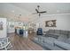 Open-concept living space with modern furnishings, including a sectional, hardwood floors, and custom mirror at 508 Horse Trail Rd, Saint George, SC 29477