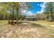 Scenic view of the property featuring a fire pit area, a house and a large metal outbuilding at 508 Horse Trail Rd, Saint George, SC 29477