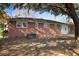 Spacious backyard featuring a brick house with several windows and a large tree shading the yard at 5314 Albert St, North Charleston, SC 29418