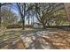 Exterior backyard with mature trees and shed at 5314 Albert St, North Charleston, SC 29418