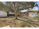 Backyard view featuring a brick home and mature trees at 5314 Albert St, North Charleston, SC 29418