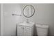 Updated bathroom with white vanity and round mirror at 5314 Albert St, North Charleston, SC 29418