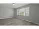 Bright bedroom features a large window and sleek gray wood-look flooring at 5314 Albert St, North Charleston, SC 29418