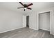 Bedroom featuring modern ceiling fan, wood-look flooring, and closet space at 5314 Albert St, North Charleston, SC 29418