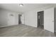 Bright bedroom with modern gray flooring, neutral walls, and multiple doors for easy access at 5314 Albert St, North Charleston, SC 29418