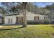 Charming home featuring a well-maintained front lawn, a tree, and a brick and white exterior at 5314 Albert St, North Charleston, SC 29418