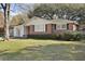 Brick home with a manicured lawn and mature landscaping at 5314 Albert St, North Charleston, SC 29418