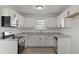 Updated kitchen features stainless steel appliances, granite counters, and white cabinets at 5314 Albert St, North Charleston, SC 29418