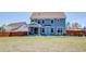 Charming blue two-story home features a covered patio and a spacious backyard for outdoor enjoyment at 5525 Alpine Dr, Summerville, SC 29483