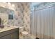 Bathroom featuring patterned wallpaper, vanity, and modern shower curtain at 5525 Alpine Dr, Summerville, SC 29483