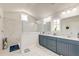 A bathroom featuring white marble and stylish gray cabinetry, with double sinks and glass-enclosed shower at 5525 Alpine Dr, Summerville, SC 29483