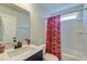 Bathroom featuring single vanity, granite countertop, and South Carolina Gamecocks shower curtain at 5525 Alpine Dr, Summerville, SC 29483