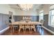 Elegant dining room featuring coffered ceilings, modern lighting, panelled walls and hardwood floors at 5525 Alpine Dr, Summerville, SC 29483