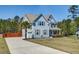 Charming two-story home with manicured lawn, palm tree, and attached garage at 5525 Alpine Dr, Summerville, SC 29483