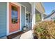 Inviting front porch with rocking chair, potted plants, and welcoming entrance at 5525 Alpine Dr, Summerville, SC 29483