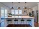 Bright kitchen with white quartz countertop island, stainless steel appliances, and bar stool seating at 5525 Alpine Dr, Summerville, SC 29483
