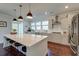 Modern kitchen features a large island with seating, pendant lights, and stainless steel appliances at 5525 Alpine Dr, Summerville, SC 29483