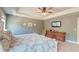 A serene main bedroom has gray walls, a bed with patterned linens, and an entertainment center at 5525 Alpine Dr, Summerville, SC 29483