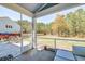 Screened-in porch overlooking a spacious backyard with mature trees and outdoor seating area at 5525 Alpine Dr, Summerville, SC 29483