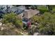 Overhead shot of a brick house with lush green trees in a suburban neighborhood; includes a beautiful pink dogwood tree at 56 Parkwood Ave, Charleston, SC 29403