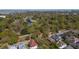 Panoramic aerial view of the neighborhood with mature trees, a pond, and rooftops of nearby homes at 56 Parkwood Ave, Charleston, SC 29403